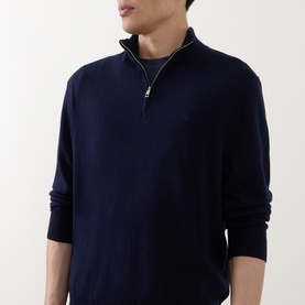 Model wearing Calvin Klein Monogram Logo Half-Zip Sweater in Dark Sapphire, featuring funnel neck, silver half-zip placket and long sleeves