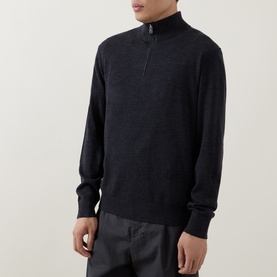 Model wearing Calvin Klein Monogram Logo Half-Zip Sweater in Gunmetal Heather, funnel neck, half-zip placket, styled with grey trousers