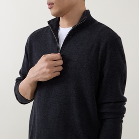 Model wearing Calvin Klein Monogram Logo Half-Zip Sweater in Gunmetal Heather, styled with a white crew-neck tee underneath.