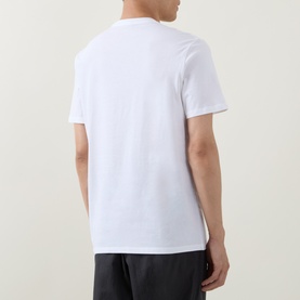 Model wearing Calvin Klein Graphic Logo T-Shirt in Bright White. Rear view showing crew neck, short sleeves, and straight hem. Styled with dark