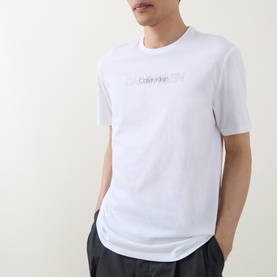 Model wearing Calvin Klein Graphic Logo T-Shirt in Bright White with crew neck, short sleeves and contrast logo print across chest