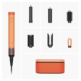 Dyson Supersonic hair dryer in orange with dark attachments including barrels, styler, and storage case displayed as full set