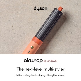 Dyson Airwrap Coanda 2x Ceramic multi-styler in apricot, shown at an angle on a neutral stone background.