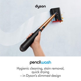 Dyson Pencilwash handheld fabric cleaner in black and copper, held in hand, highlighting slim design for stain removal and quick drying