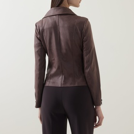 Model wearing Joseph Ribkoff Mink jacket, rear view, fitted silhouette with seam detailing, styled with black trousers