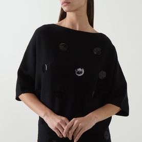 Model wearing Joseph Ribkoff Sequin Embellished Knitted Sweater in black with boat neckline, dropped shoulders and short sleeves