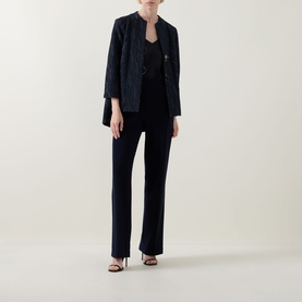 Model wearing Joseph Ribkoff Midnight Blue trousers with matching navy textured blazer and black heeled sandals.