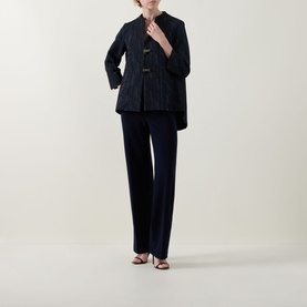 Model wearing Joseph Ribkoff Midnight Blue wide-leg trousers, styled with a navy quilted jacket and strappy heeled sandals.