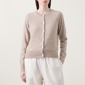 Model wearing Lucy Nagle The Everyday Cardigan in Light Weight Beige, fine knit, round neck, logo disc buttons, styled with white wide-leg trousers