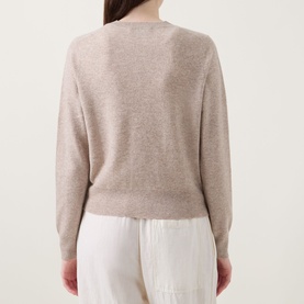 Model wearing Lucy Nagle The Everyday Cardigan in Light Weight Beige, fine knit, round neck, long sleeves, ribbed trims, back view, styled with white