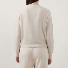 Model wearing Lucy Nagle The Everyday Cardigan in Pearl, fine knit, round neck, long sleeves, ribbed trims, shown from the back with matching