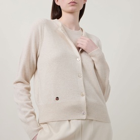 Model wearing Lucy Nagle The Everyday Cardigan in Pearl, fine knit, round neck, gold logo disc, styled with matching trousers