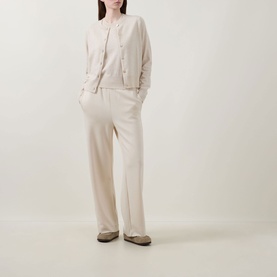 Model wearing Lucy Nagle The Everyday Cardigan in Pearl, fine knit with round neck and ribbed trims, styled with matching wide-leg trousers