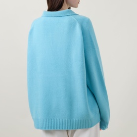 Model wearing Lucy Nagle The Cashmere Collar Sweater in Bambino blue, back view showing dropped shoulders, flat collar and ribbed hem