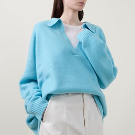 Model wearing Lucy Nagle The Cashmere Collar Sweater in Bambino blue, with flat collar and notched neckline, styled with white wide-leg trousers