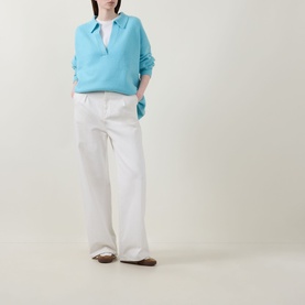 Model wearing Lucy Nagle The Cashmere Collar Sweater in Bambino blue with notched neckline, styled with white wide-leg trousers and brown loafers