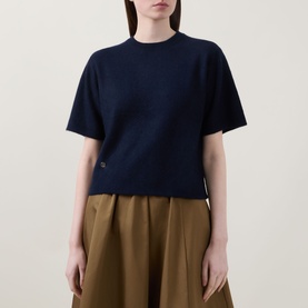 Model wearing Lucy Nagle The Cashmere Top in Midnight Slate, crew neck, short sleeves, dropped shoulders, styled with tan wide-leg trousers