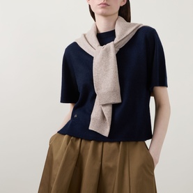 Model wearing Lucy Nagle The Cashmere Top in Midnight Slate, short sleeves, crew neck, styled with a draped oatmeal scarf and tan wide-leg trousers