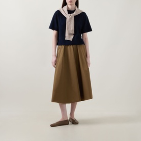 Model wearing Lucy Nagle The Cashmere Top in Midnight Slate, styled with a draped scarf, tan midi skirt and flat loafers