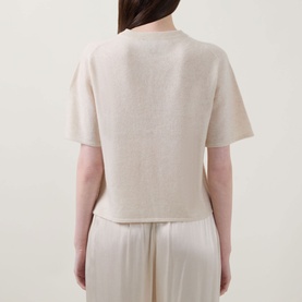 Model wearing Lucy Nagle The Cashmere Top in Pearl, rear view, showing short sleeves, dropped shoulders and straight hemline, styled with white