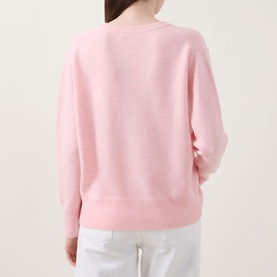 Model wearing Lucy Nagle The Elevated Cashmere Sweater in Crystal Rose, back view, dropped shoulders, ribbed hem, styled with white trousers