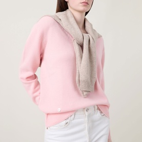 Model wearing Lucy Nagle The Elevated Cashmere Sweater in Crystal Rose, styled with a beige knit scarf and white jeans.