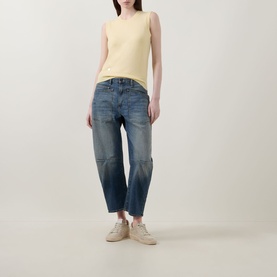 Model wearing Lucy Nagle The Crew Cashmere Top in Primrose, styled with mid-blue barrel-leg jeans and cream trainers.