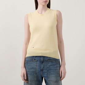 Model wearing Lucy Nagle The Crew Cashmere Top in Primrose, sleeveless fine knit with crew neck and logo disc detail, styled with blue jeans