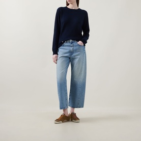 Model wearing Lucy Nagle The Everyday Cashmere Sweater in Midnight Slate, crew neck, ribbed trims, styled with light blue wide-leg jeans and tan