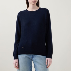 Model wearing Lucy Nagle The Everyday Cashmere Sweater in Midnight Slate, crew neck, ribbed trims, logo disc detail, styled with light blue jeans.