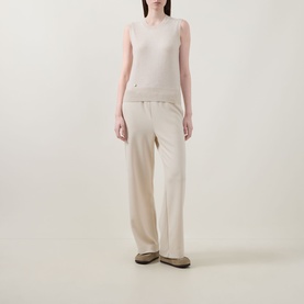 Model wearing Lucy Nagle The Crew Cashmere Top in Pearl, sleeveless fine knit with ribbed trims, styled with wide-leg cream trousers and taupe