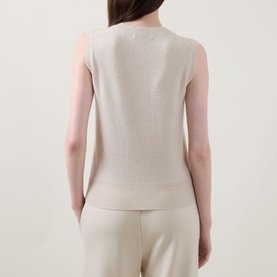 Model wearing Lucy Nagle The Crew Cashmere Top in Pearl, sleeveless fine knit, back view, styled with matching trousers.
