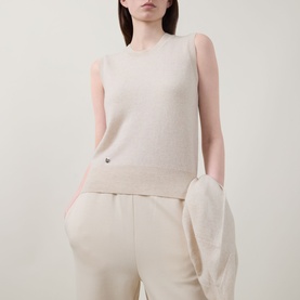 Model wearing Lucy Nagle The Crew Cashmere Top in Pearl, sleeveless fine knit with crew neck and logo disc, styled with cream wide-leg trousers