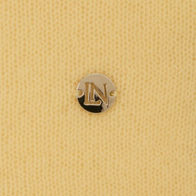 Lucy Nagle The Travel Wrap primrose cashmere-blend scarf, close-up of circular silver LN logo disc detail