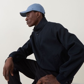 Model with Lululemon Classic Ball Cap in Steel Blue, styled with a navy zip-up jacket and trousers
