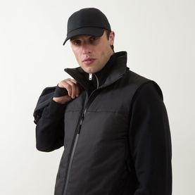 Model with Lululemon Classic Ball Cap in black, styled with a black padded high-neck gilet and jacket