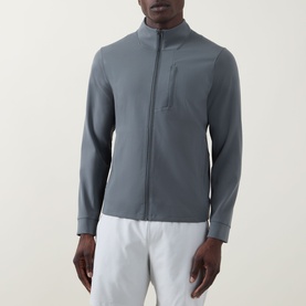 Model wearing Lululemon Sojourn Jacket in Onyx Grey, zip-front with chest pocket, styled with white trousers