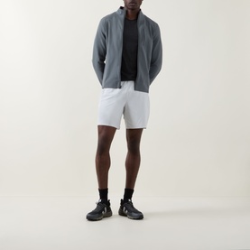 Model wearing Lululemon Sojourn Jacket in Onyx Grey, styled with white shorts and black trainers