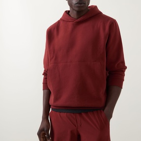 Model wearing Lululemon Cranberry Charm hoodie with matching joggers and black waistband detail visible.