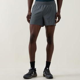 Model wearing Lululemon Pace Breaker Shorts 5" in Onyx Grey, styled with black socks and grey trail trainers.