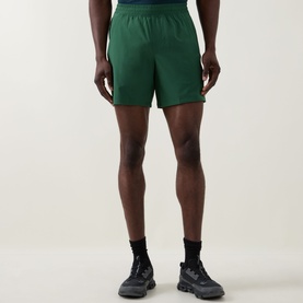 Model wearing Lululemon Green Cove performance shorts, styled with black socks and dark trainers