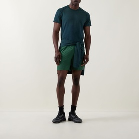 Model wearing Lululemon Green Cove performance shorts with matching green T-shirt and black trainers.