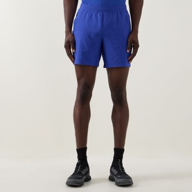 Model wearing Lululemon Pace Breaker Linerless Shorts 7" in Beach Ball Blue, styled with black socks and chunky black trainers