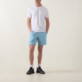 Model wearing Lululemon Seafoam performance shorts with white T-shirt, white socks and black trainers