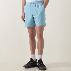 Model wearing Lululemon seafoam shorts with elasticated drawstring waist, styled with white socks and black trainers.