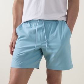 Model wearing Lululemon seafoam shorts with elasticated waistband and white drawstring, styled with a white T-shirt.