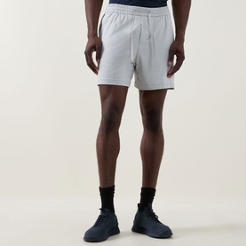Model wearing Lululemon shorts in Heathered Vapor/Heathered Silver Drop, styled with black socks and dark blue trainers.