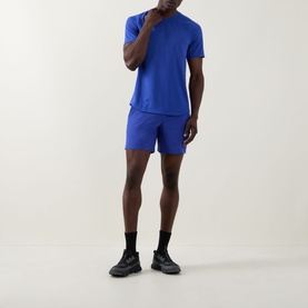 Model wearing Lululemon Beach Ball Blue performance T-shirt with matching shorts, black socks and dark trainers.