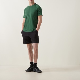 Model wearing Lululemon License to Train Short-Sleeve T-Shirt in Green Cove, styled with black shorts and dark trainers