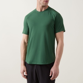 Model wearing Lululemon License to Train Short-Sleeve T-Shirt in Green Cove, styled with black shorts. Relaxed crew neck, raglan sleeves.
